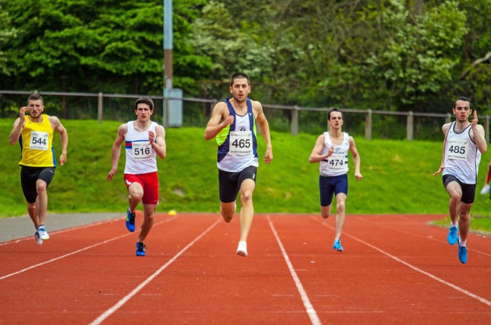 Five runners on the track at the East District Champs